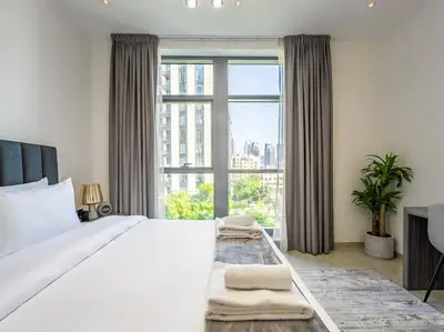 a bedroom with a large bed and a large window at Modern Downtown Escape 1Bedroom with Upscale Comfort in Dubai