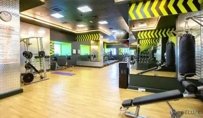 a gym with weights and equipment in a room at Modern 1BR Apartment in Elite Residences, Dubai Marina by Deluxe Holiday Homes in Dubai