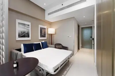 a hospital room with a bed and a table at Your Dream Home in Damac Maison Prive by Suiteable in Dubai
