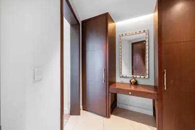 a bathroom with a wooden vanity and a mirror at The Address Fountain Views - Residence 2 Bedroom with Burj Khalifa view in Dubai