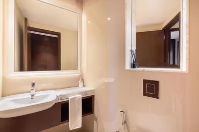 a bathroom with a sink and a mirror at The Address Fountain Views - Residence 2 Bedroom with Burj Khalifa view in Dubai