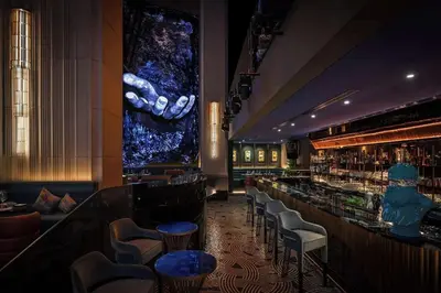 a bar with a bunch of stools in a room at EMAAR Residences Fashion Avenue Full Burj Khalifa views Studio in Dubai