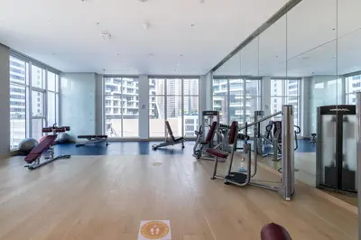 a gym with treadmills and ellipticals in a building at GuestReady - Modern studio with Dubai Canal View in Dubai