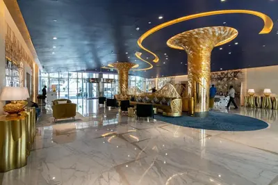 a lobby with two gold columns in a building at GuestReady - Modern studio with Dubai Canal View in Dubai