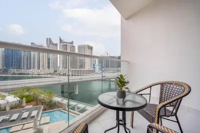 a balcony with a table and chairs and a view of the city at GuestReady - Modern studio with Dubai Canal View in Dubai