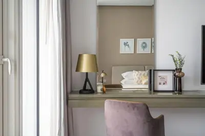 a bedroom with a table with a chair and a bed at GuestReady - Modern studio with Dubai Canal View in Dubai