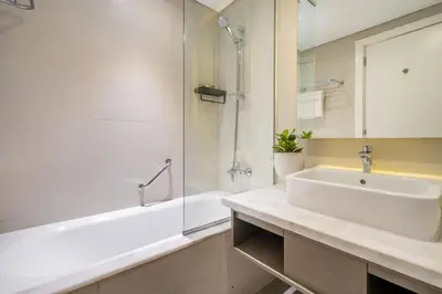 a bathroom with a sink and a shower and a tub at GuestReady - Stylish studio with Dubai Canal view in Dubai