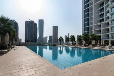 a swimming pool in a city with tall buildings at GuestReady - Stylish studio with Dubai Canal view in Dubai