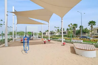 a playground with a large umbrella at Cozy Studio in Damac Hills in Dubai