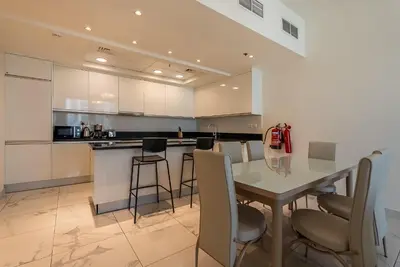 a kitchen with a table and chairs in a room at Noora Tower I Habtoor City I Spacious 3BDR plus maid room I Business Bay in Dubai