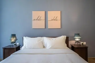 a bedroom with three pictures hanging above a bed at Noora Tower I Habtoor City I Spacious 3BDR plus maid room I Business Bay in Dubai