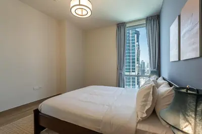 a bedroom with a large bed and a window at Noora Tower I Habtoor City I Spacious 3BDR plus maid room I Business Bay in Dubai