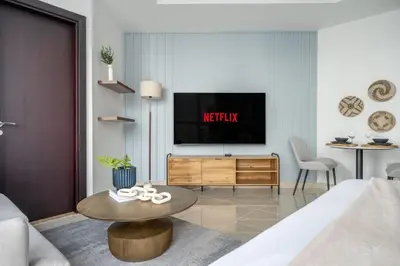 a living room with a television and a table at GuestReady - A Sanctuary Above the Clouds in Dubai