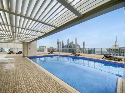 a large swimming pool on top of a building at Stylish Studio in Prime Location in Dubai