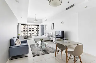 a living room with a couch and a table at Stylish Studio in Prime Location in Dubai