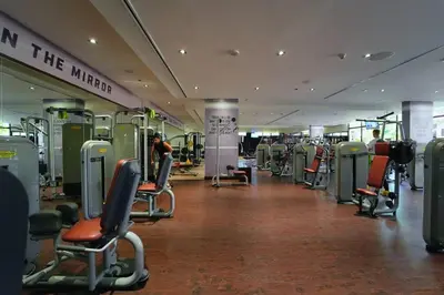a gym with chairs and machines in a building at FIRST CLASS 1BR in Royale Apartment on the Palm in Dubai