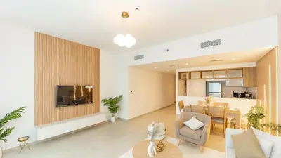a living room with a couch and a dining room at Burj Khalifa view with Grass Turf Balcony-Downtown by Tanami Holiday Homes in Dubai