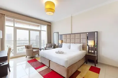a bedroom with a large bed with a large window at Siraj Tower - Colourful Studio in Dubai