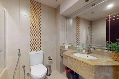 a bathroom with a toilet and a sink at Siraj Tower - Colourful Studio in Dubai