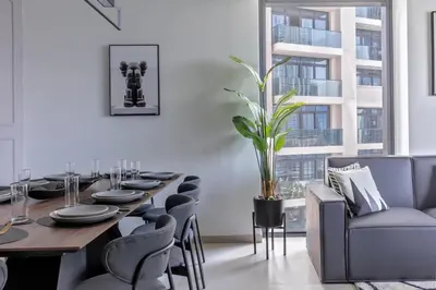 a dining room with a long table and chairs at Luxurious 4BR Apartment w/ Prime Burj Khalifa View in Dubai