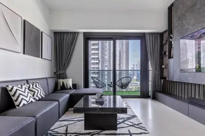a living room with a couch and a table at Luxurious 4BR Apartment w/ Prime Burj Khalifa View in Dubai