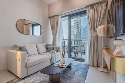 a living room with a couch and a large window at Modern Brand New 1 BR Apartment in ZADA Tower in Dubai