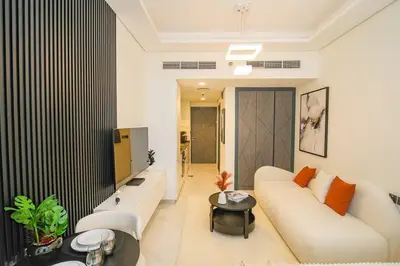 a living room with a white couch and a tv at Magnificent studio-One of kind in Dubai in Dubai