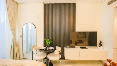 a bedroom with a table and chairs and a tv at Magnificent studio-One of kind in Dubai in Dubai