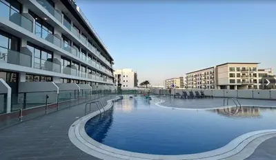 a large building with a large swimming pool in front of it at Magnificent studio-One of kind in Dubai in Dubai