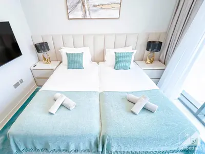 a bedroom with two beds with crosses on them at Spacious 3.5 Bedroom Apartment in Burj Royale in Dubai