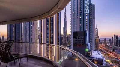 a view of a city at night from a building at Luxe 6BR Penthouse with Burj View & Private Cinema in Dubai