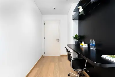 a room with a black table and two chairs at Luxe 6BR Penthouse with Burj View & Private Cinema in Dubai