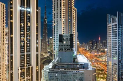 a view of a city skyline at night at Luxe 6BR Penthouse with Burj View & Private Cinema in Dubai
