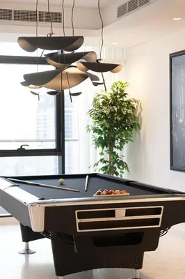 a billiard table in a living room with at Luxe 6BR Penthouse with Burj View & Private Cinema in Dubai