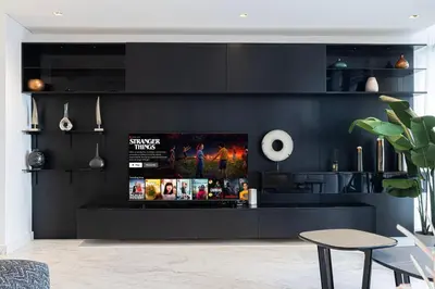 a living room with a black wall at Luxe 6BR Penthouse with Burj View & Private Cinema in Dubai