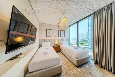 a hotel room with two beds and a large window at 52 I 42 Tower by Emaar, Dubai Marina in Dubai