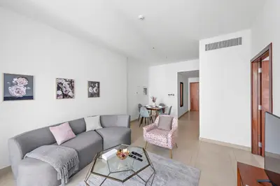 a living room with a couch and a table at Stylish 1 BR in Dubai Marina in Dubai