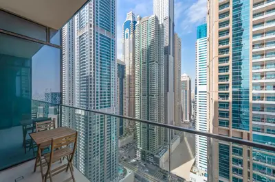 a balcony with a table and a view of a city at Stylish 1 BR in Dubai Marina in Dubai