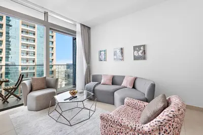 a living room with a couch and a table at Stylish 1 BR in Dubai Marina in Dubai