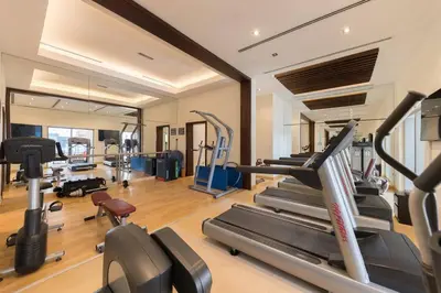 a gym with several treadmills and elliptical machines at Downtown Studio next to Dubai Opera, Dubai Mall in Dubai