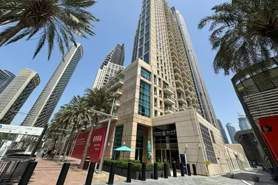 a tall building with palm trees in front of it at Downtown Studio next to Dubai Opera, Dubai Mall in Dubai