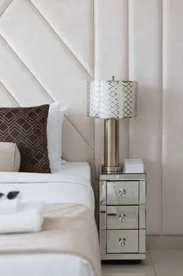 a bedroom with a bed and a lamp on a night stand at Downtown Studio next to Dubai Opera, Dubai Mall in Dubai