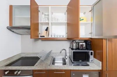 a kitchen with a sink and a microwave at Downtown Studio next to Dubai Opera, Dubai Mall in Dubai