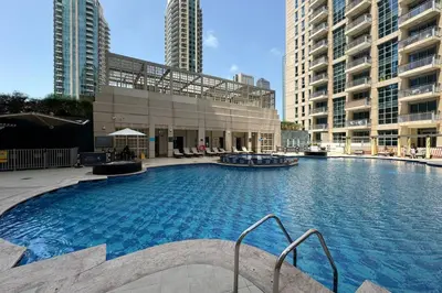 a large swimming pool in a building with tall buildings at Downtown Studio next to Dubai Opera, Dubai Mall in Dubai