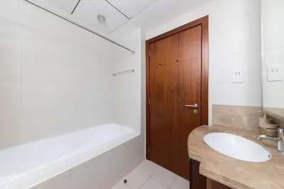 a bathroom with a sink and a tub and a toilet at Downtown Studio next to Dubai Opera, Dubai Mall in Dubai