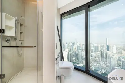 a bathroom with a shower and a toilet and a window at Ultra Luxurious 4BR with Assistant Room in The Address Residences, JBR by Deluxe Holiday Homes in Dubai