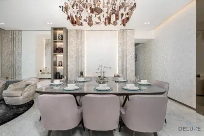 a dining room with a table and chairs at Ultra Luxurious 4BR with Assistant Room in The Address Residences, JBR by Deluxe Holiday Homes in Dubai