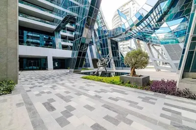 a large building with a tree in front of it at Jone brand-new aptm near Dubai Mall & Burj Khalifa in Dubai