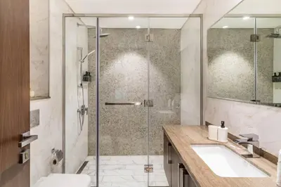 a bathroom with a shower with a sink and a toilet at Jone brand-new aptm near Dubai Mall & Burj Khalifa in Dubai