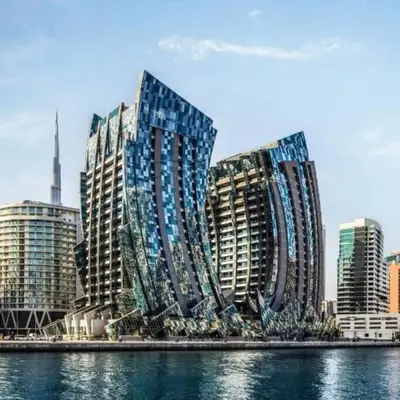a large building with many windows next to the water at Jone brand-new aptm near Dubai Mall & Burj Khalifa in Dubai